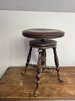 Full view of organ stool showing seat, legs and fish feet