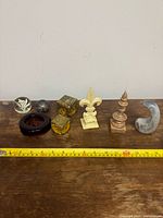 overview of all eight paperweights on table with tape measure