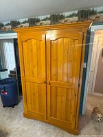 Full frontal view of pine wardrobe cupboard closed
