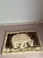 Full view of rectangular fur wall hanging with polar bear design