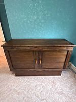 Front view of closed wood Sleep Chest cabinet bed