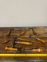 Group view of all tools laid out with measuring tape for scale