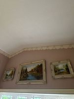 All three framed paintings hung on wall