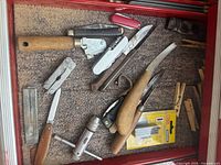 Drawer containing assorted hand tools and knives
