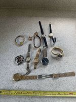 Group shot of all wristwatches and bracelet laid out