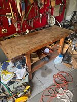 Full view of wood workbench with vices and surrounding tools