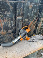 Full view of Worx blower vacuum lying on bench