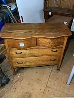 Front view showing four drawers and curved front