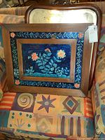 Front view of framed floral art on patterned chair