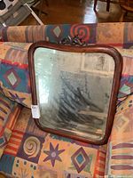 Front view of mirror on patterned sofa