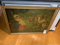 Full view of framed print leaning against wall