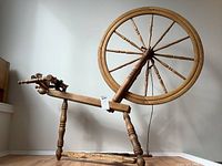 Full view of treadle spinning wheel showing frame and large wheel