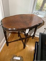 Full view of antique side table against wall