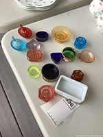 Overview showing all coloured glass salt cellars on table