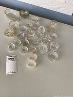 Group shot of all 24 glass salt cellars on table