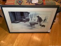 Full view of framed signed print on floor