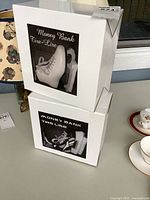 Two stacked retail boxes for Verdici figure skate money banks