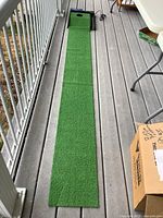 Full view of 9-ft green turf mat leading to black Top Flite XL return base