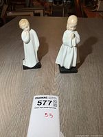 Both Royal Doulton figurines on table