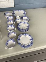 Full group showing cups, saucers, snack plates, cream and sugar with tray, serving plate