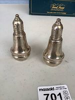 Both sterling-cased glass shakers front view