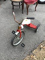 Front angled view showing frame, handlebars, pedals, wheels