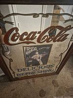 Full view of Coca-Cola advertising mirror showing logo, print, wording and frame