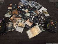 Overview of loose MTG cards spread with deck boxes