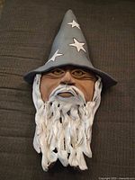 Front view of ceramic wizard sculpture showing full form and colors