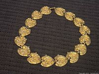 Full view of necklace arranged in circle showing all links and clasp