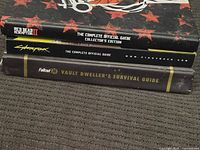 Spines of the three hardcover strategy guides showing titles