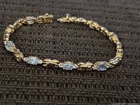 Entire bracelet laid flat showing design, stones, clasp