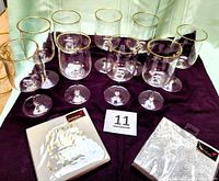 Front view of 10 Lenox gold-rim glasses and 2 Papyrus napkin packs