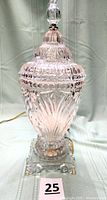 Full view of crystal lamp showing urn shape, lid, finial, base and cord
