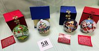 Four Li Bien ornaments in front of their boxes with ID card 58