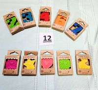 All 10 boxed Papyrus candle toppers laid out