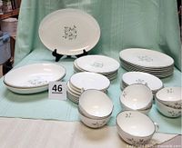 Entire 44-piece set displayed: plates, bowls, cups, platter
