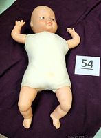 Front view of baby doll showing vinyl limbs and cloth torso