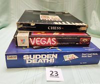 Stacked boxes of Chess, Vegas, Sudden Death! showing titles and brands