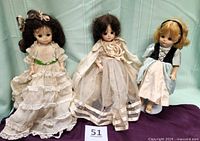 Front view of the three 14-inch Madame Alexander dolls standing