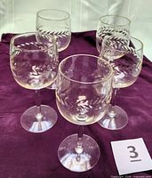 group of five etched wine glasses frontal view