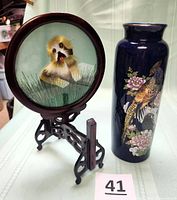 Embroidery on stand and Kutani vase side by side