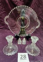 Lot overview showing candlesticks, plate, salt & pepper shakers
