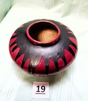 Top view of burgundy and black drip glaze ceramic vase showing opening
