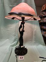 Full view of lamp showing figural base, shade, cord, height reference