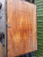 Rear view of wooden curio cabinet showing hanging bracket and back panel wear