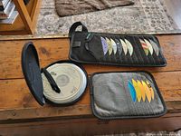 All three CD cases, two open showing discs