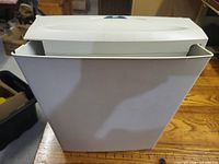 Front view of shredder seated in waste bin