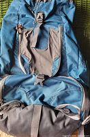 Front view of Ferrino blue backpack showing pockets, buckles and hip belt