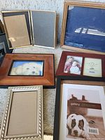 Assorted tabletop frames in various materials and packaged Umbra Gallery frame